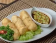 A golden-brown, crispy pempek served with tangy kuah cuko sauce.