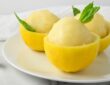 Sorbet lemon berwarna cerah tersaji dalam mangkuk, dihiasi daun mint segar untuk tampilan yang menggoda